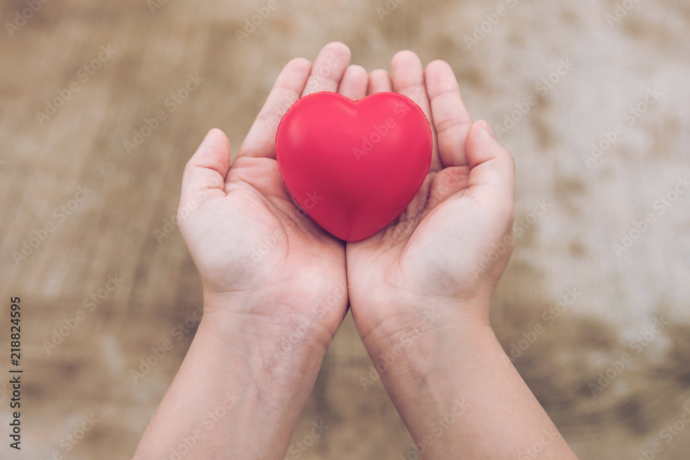 Fototapeta premium Red heart ball : Stress reliever foam ball the red heart shape on woman hand. Gift valentine's Day