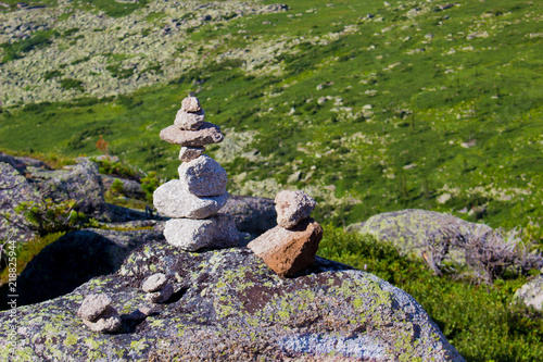 Cairn stone pyramid on rock in mountains © Вера Тихонова