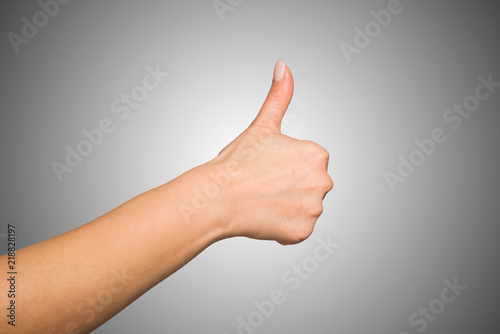 Female hand giving thumbs up
