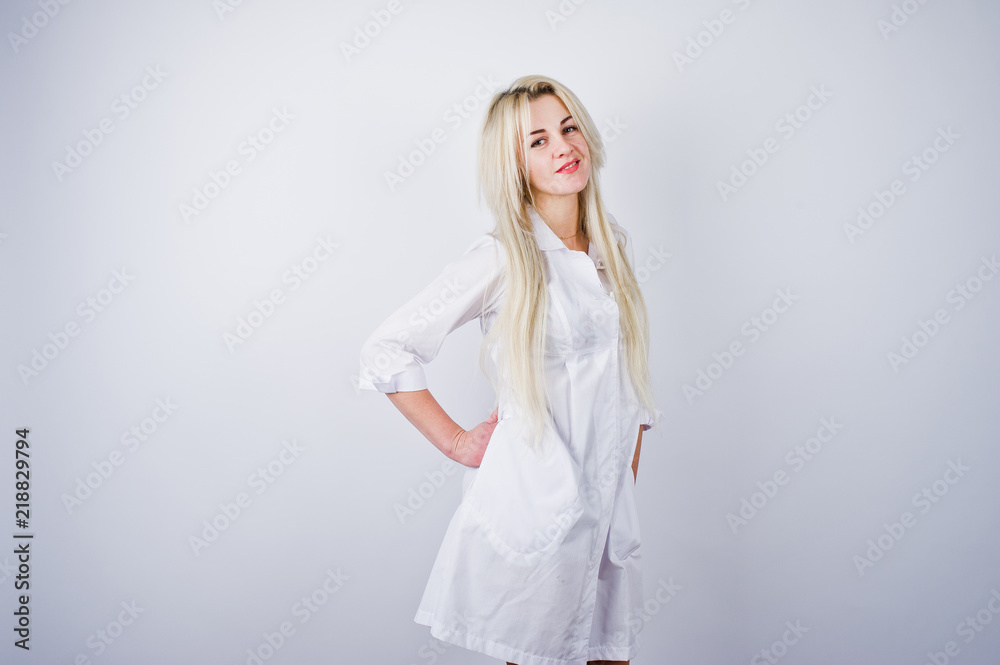 Attractive blonde female doctor or nurse  in lab coat isolated on white background.
