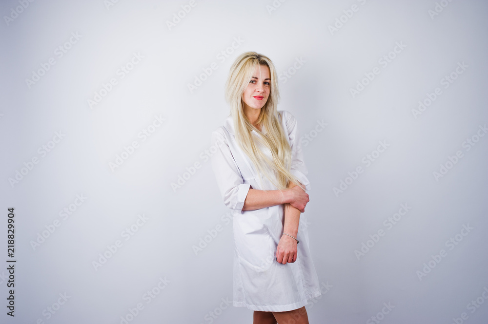 Attractive blonde female doctor or nurse  in lab coat isolated on white background.