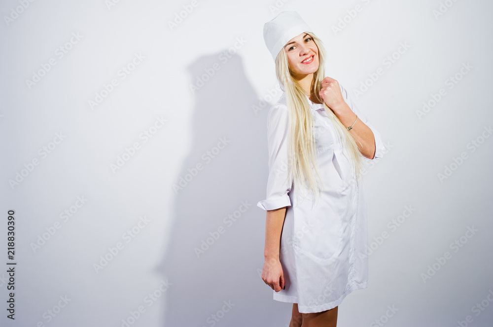 Attractive blonde female doctor or nurse in lab coat isolated on white background. Attractive blonde female doctor or nurse in lab coat isolated on white background.