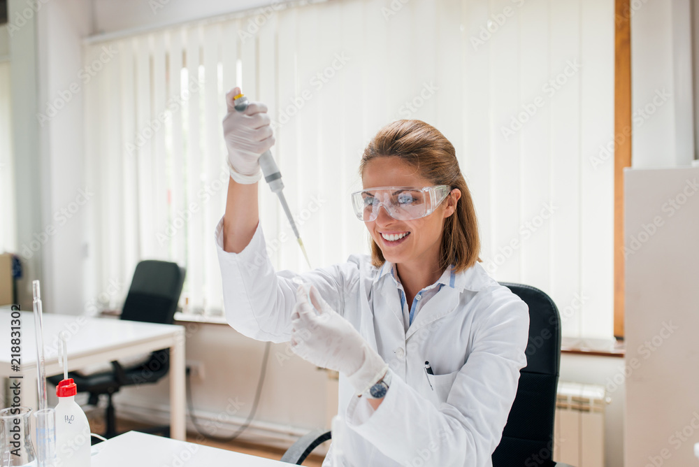 Smiling female lab technician working.