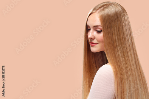 Beautiful Blonde Woman Beauty Model Girl with perfect makeup and long straight hair on light copyspace