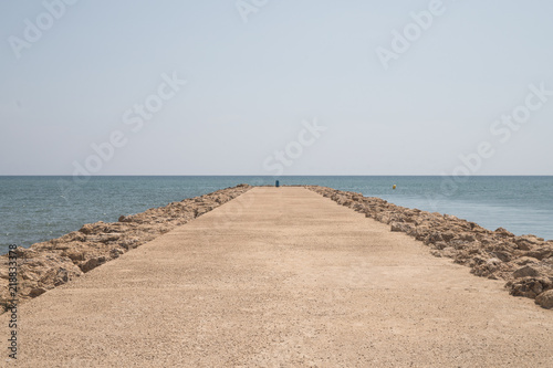 cement walkway with direction to the sea