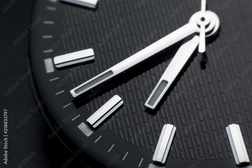 Close up clockwise on black clock face background. Wristwatch in retro style Close up clockwise on black clock face background. Wristwatch in retro style