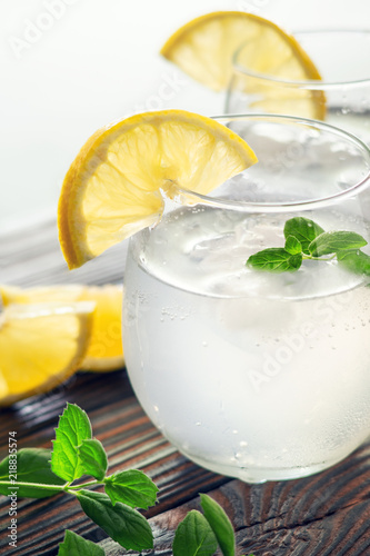 Drink with ice in a glass cup with a slice of lemon
