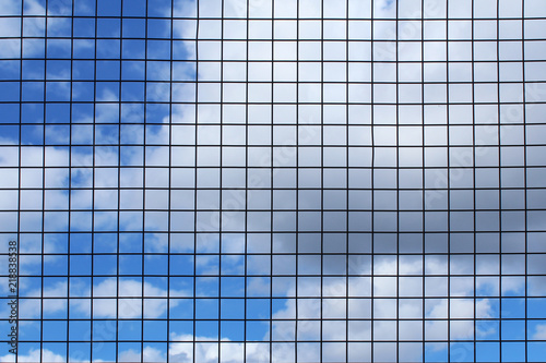 Blue sky and white clouds through a thin grid