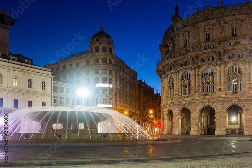 Night light of The Ferrari Square with fountain in Genoa of Italy
