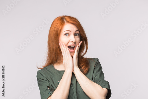 Excited happy red-haired woman on white background
