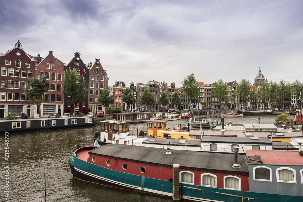 Amsterdam canal Singel with typical dutch houses and houseboats, Holland, Netherlands. 