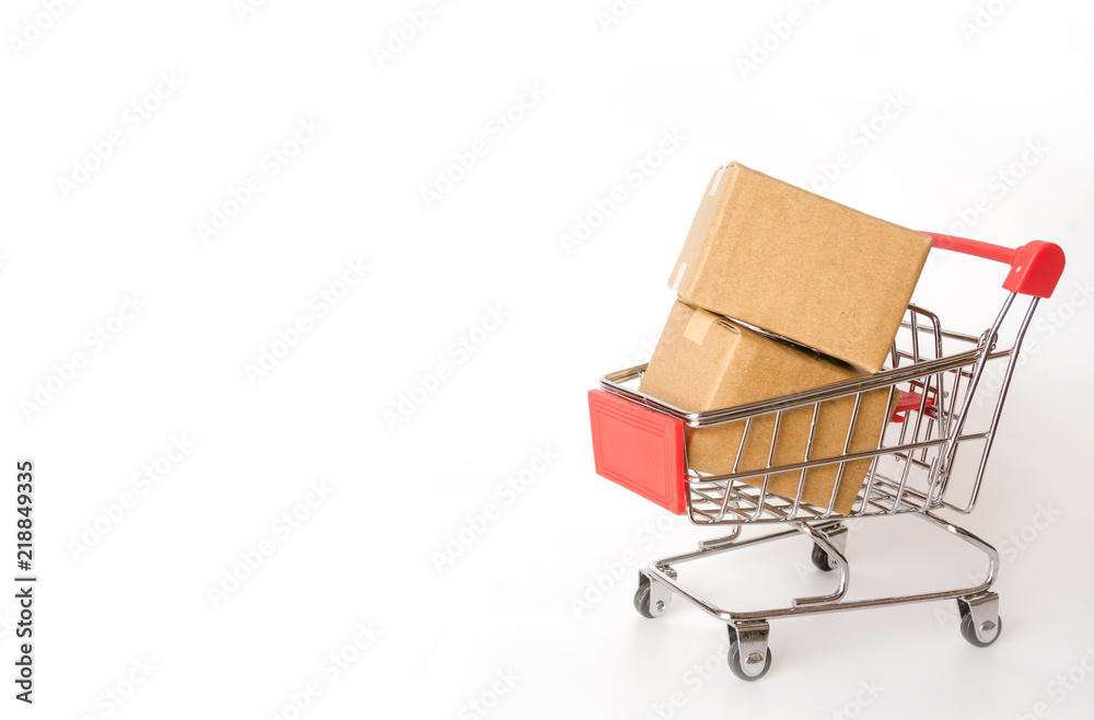 Shopping concept : Cartons or Paper boxes in red shopping cart on white background. online shopping consumers can shop from home and delivery service. with copy space