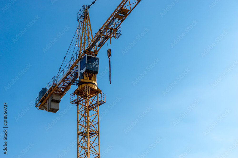 crane at a construction site - blue sky in the background crane at a construction site - blue sky in the background