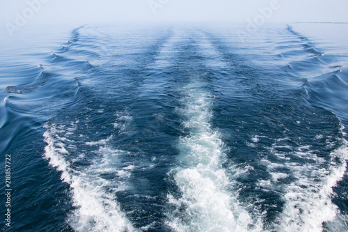 boat wake on a calm bay on a summer day