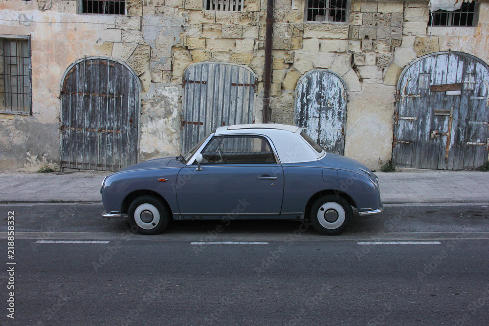 Retro nave blue car on empty Valletta street