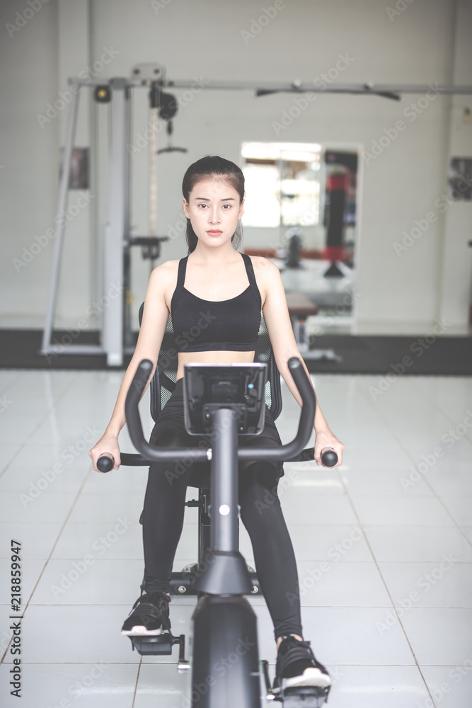 Fototapeta premium Fitness woman health exercise at gym. Healthy workout concepts.