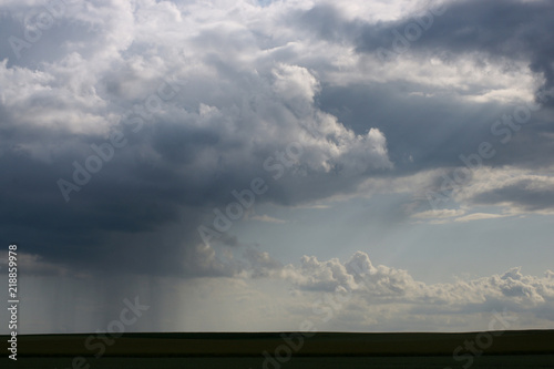 approaching rain shower over farm land © Erik