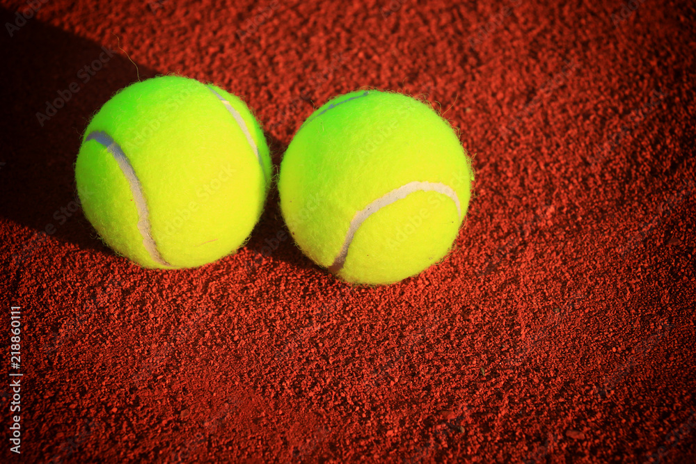 Tennis balls on a tennis clay court