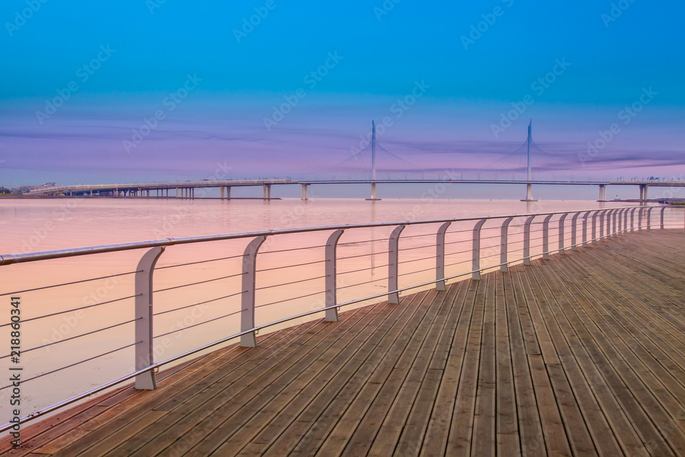 Empty embankment. Sunrise. A wooden embankment. Quay without people. Sea range. Deck.