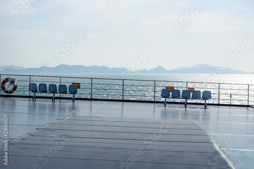 Seats with a view on deck of a ferry from Jeju to Mokpo with backlight, South Korea photo