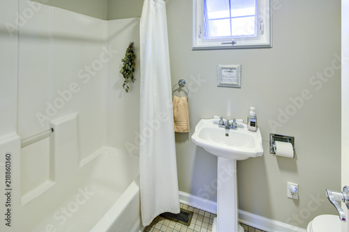 Rustic bathroom with white pedestal sink.