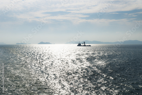 Ship in backlight in front of Jindo islands at a sunny day, South Korea photo