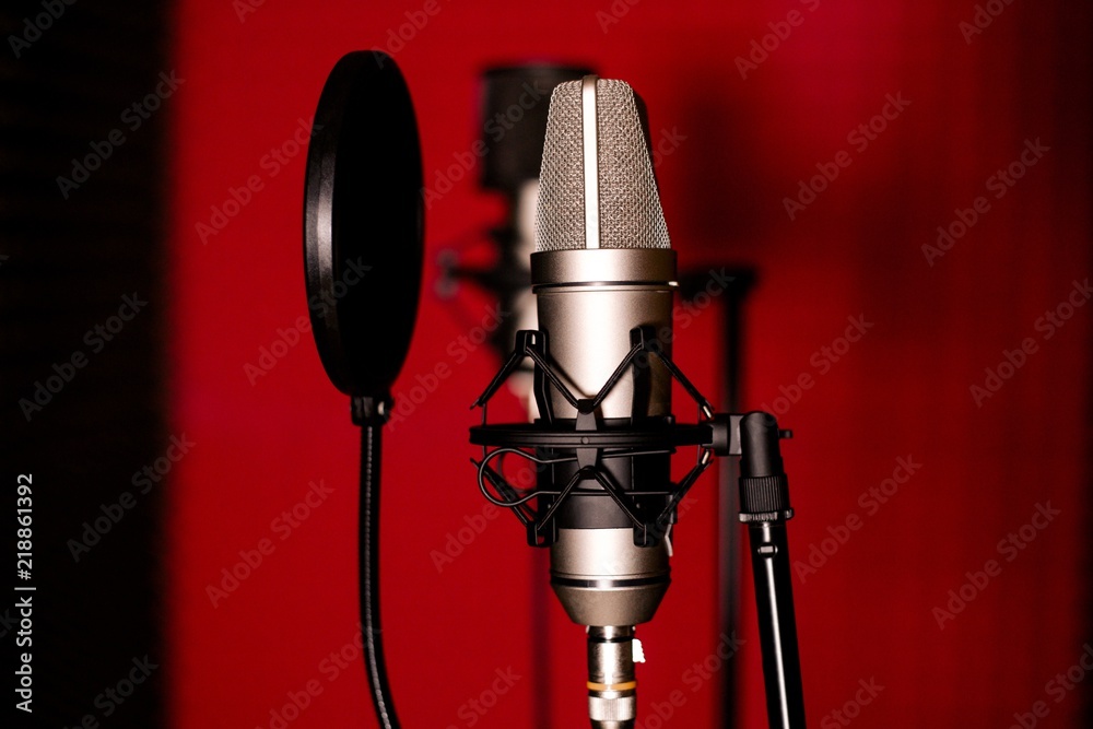 Studio microphone on a dark red background Stock Photo | Adobe Stock
