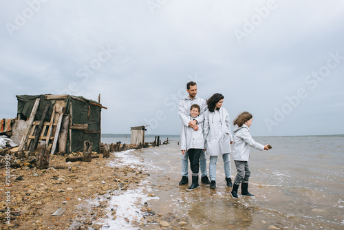 young family have a fun near the barracks on the lake