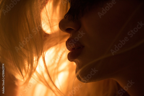 Close portraits of the girl in warm colors.Beautiful lips