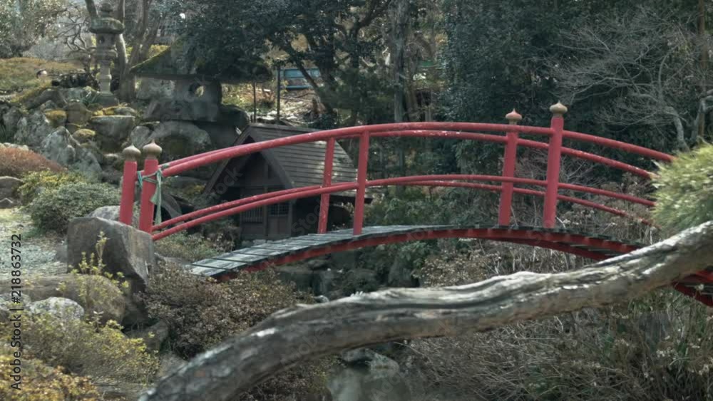 Red arched bridge over river near country road (50p) Red arched bridge over river near country road (50p)