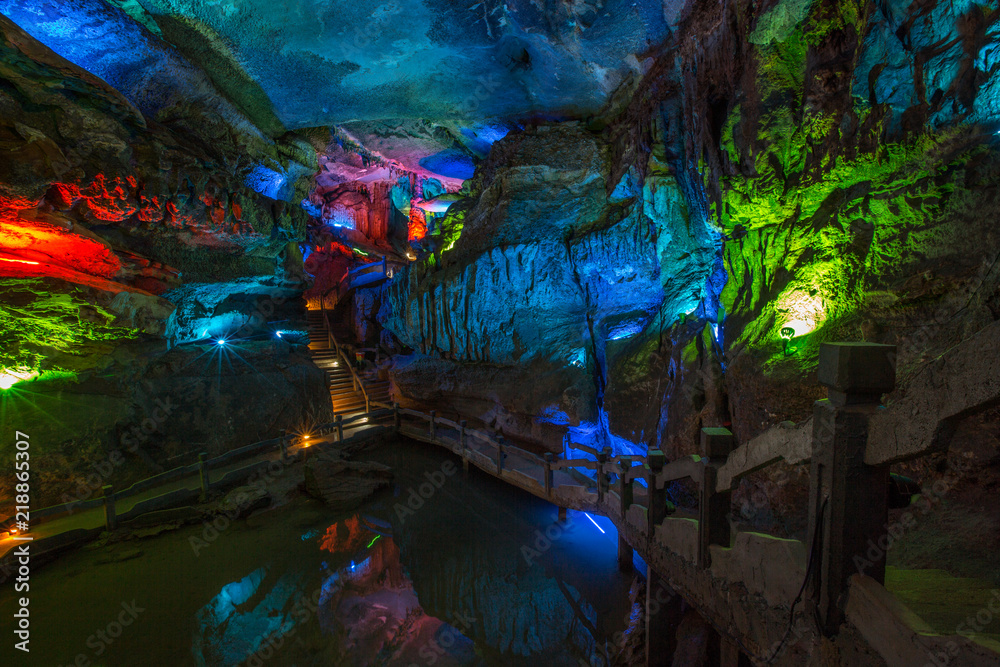 Abstract cave interior chamber photograph - colored lights, bumpy rock ...