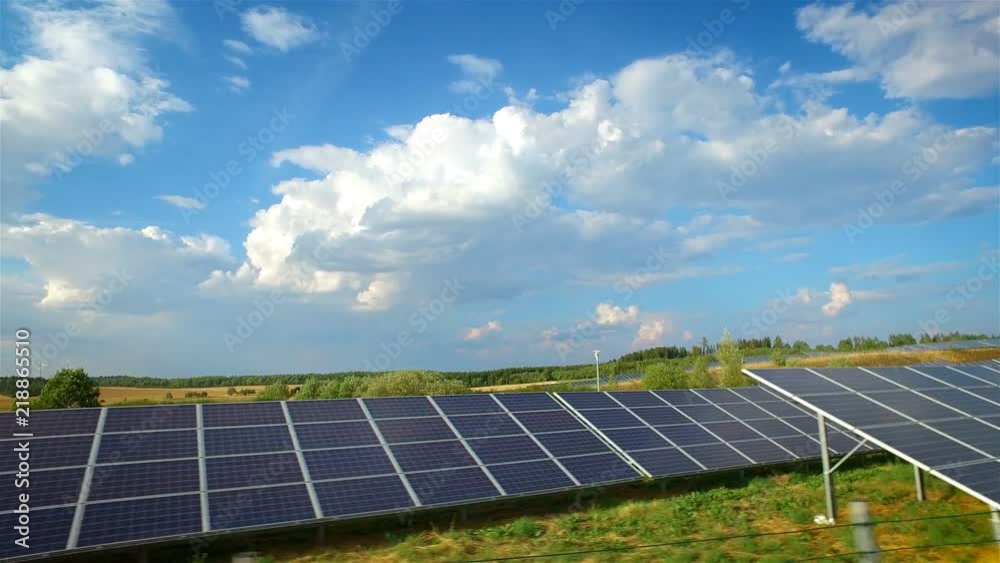 modern solar panels and power generating wind turbines on a horizon at sunset modern solar panels and power generating wind turbines on a horizon at sunset