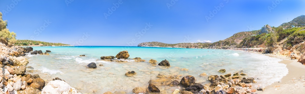Beautiful colorful beach at Crete island, Greece. Voulisma paradise beach with rocks and mountains.  Summer vacation travel holiday background concept.