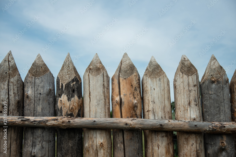 Fototapeta premium Reconstructed palisade of wood in the Museum. Ancient designs