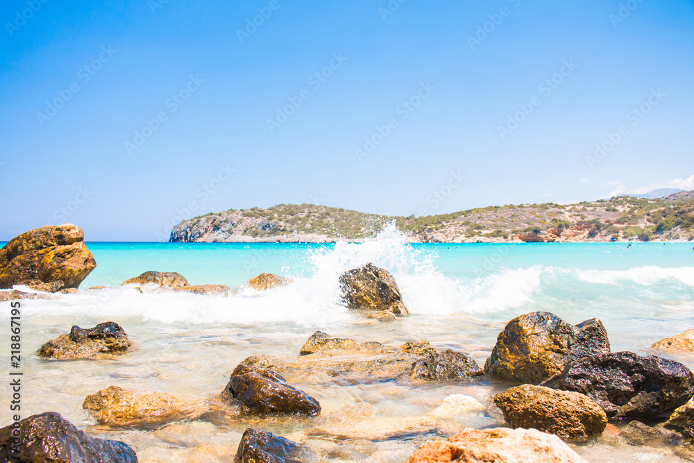 Powerful Waves on a rocky beach Voulisma, Agios Nikolaos, Istros. Greece Crete. Beautiful blue beach Travel, Tourism and Vacations Concept. Powerful Waves on a rocky beach Voulisma, Agios Nikolaos, Istros. Greece Crete. Beautiful blue beach Travel, Tourism and Vacations Concept.
