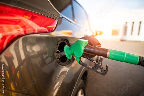 Refueling the vehicle at a gas station photo