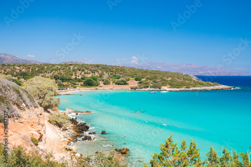 One of the best beaches on Crete, Greece. Voulisma beach near to Agios Nikolaos. Colorful beach with white sand and rocks. Tropical turquoise beach with blue sky. Summer 2018 © Artem