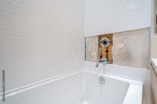 Faucet repair in the bathroom. Broken shower faucet plumbing job.