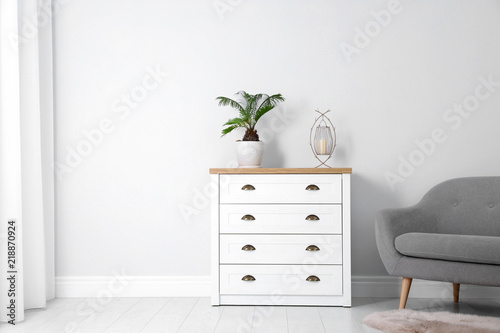 Chest of drawers in stylish living room interior photo