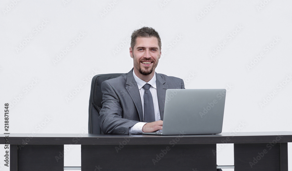 closeup.happy businessman working on laptop, sitting at desk closeup.happy businessman working on laptop, sitting at desk