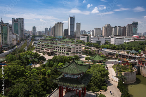 Nanchang City - China Metropolis, Jiangxi Province China. City Skyline, skyscrapers and Chinese pagoda architecture in foreground. Modern downtown city area with dense clusters of buildings. Blue Sky