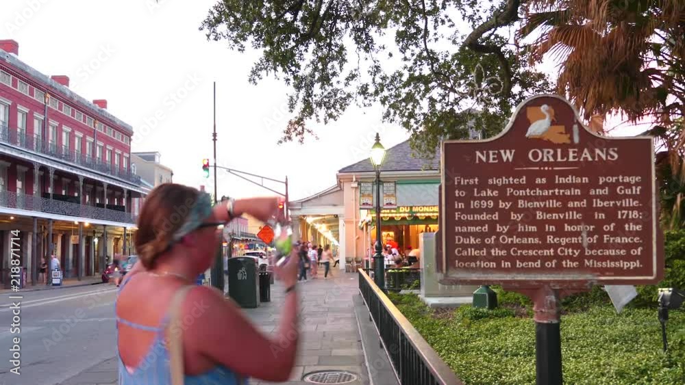 Timelapse of New Orleans Historic Signage in front of the famous Cafe Du Monde busy with tourists exploring the sights.