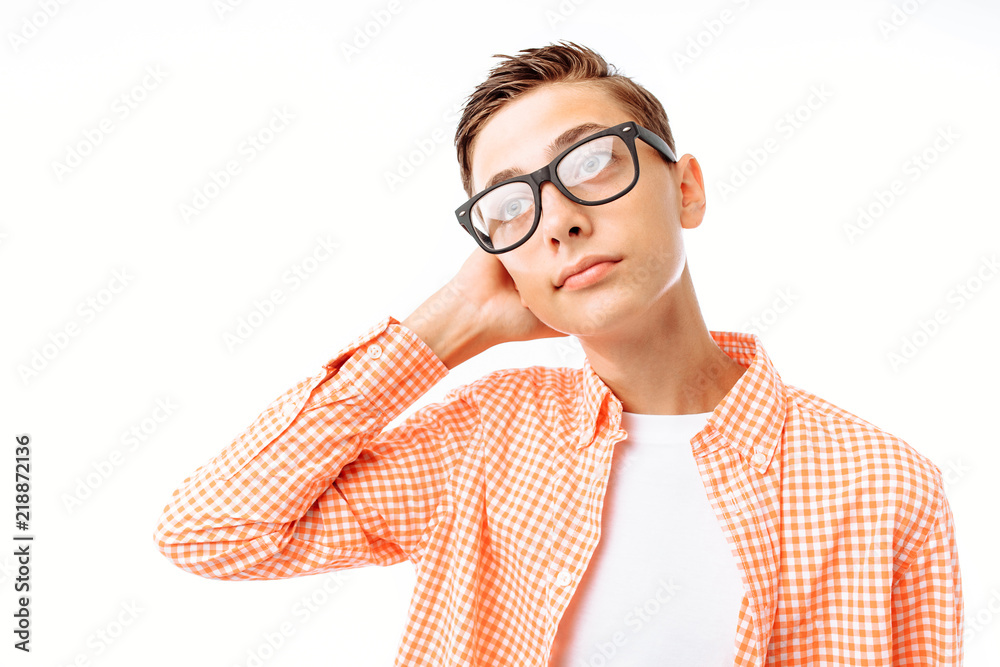 Close-up portrait of teenage boy with glasses, smiling face, in Studio on white background, pensive man Close-up portrait of teenage boy with glasses, smiling face, in Studio on white background, pensive man