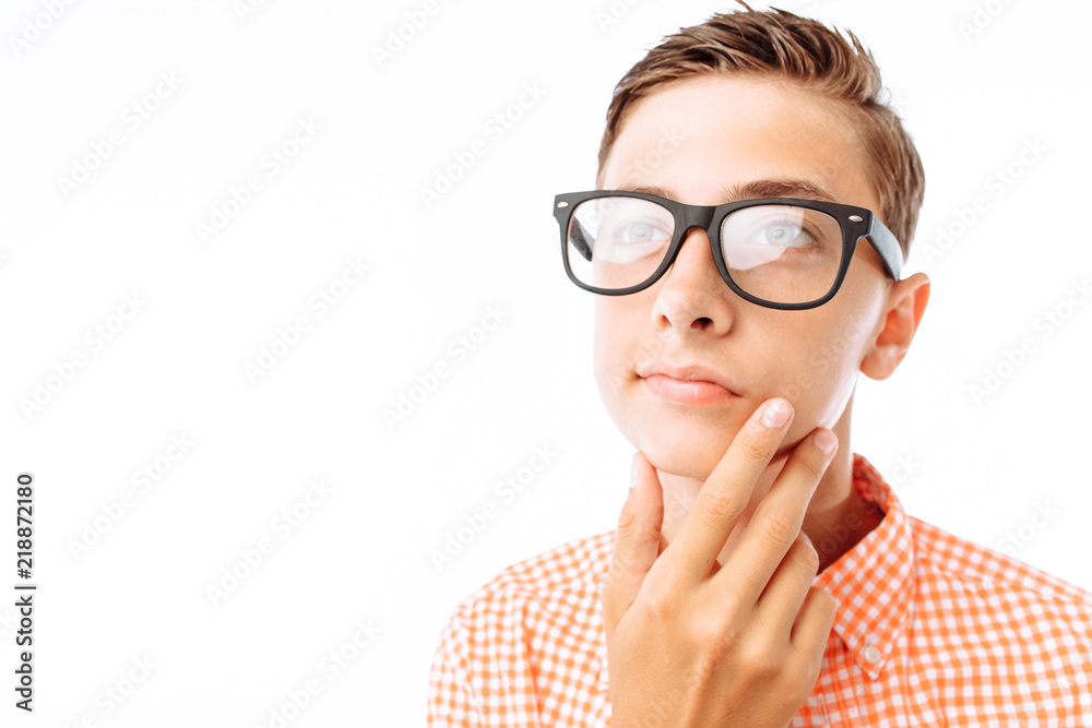 Young man with thoughtful look, guy holding hand near face, boy with glasses in Studio on white background, isolated