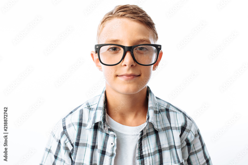 Portrait of beautiful boy with glasses, teen nerd smiling, in Studio on white background Portrait of beautiful boy with glasses, teen nerd smiling, in Studio on white background