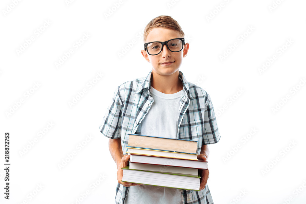 Beautiful student holding a stack of books, a botanist goes with books to study in the Studio on a white background Beautiful student holding a stack of books, a botanist goes with books to study in the Studio on a white background