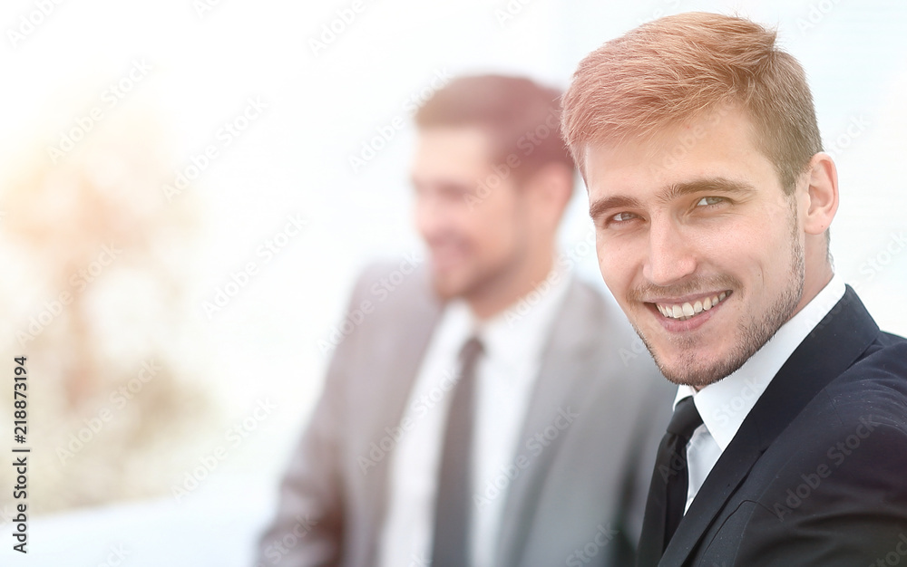 successful business man at the office on the background of business team successful business man at the office on the background of business team