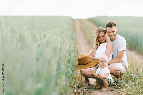 A young family have a fun with their little baby in the field © jul14ka