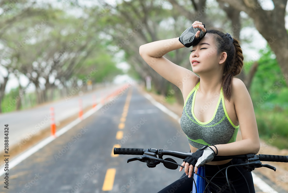Fototapeta premium Asian woman with bicycle on bike lane.