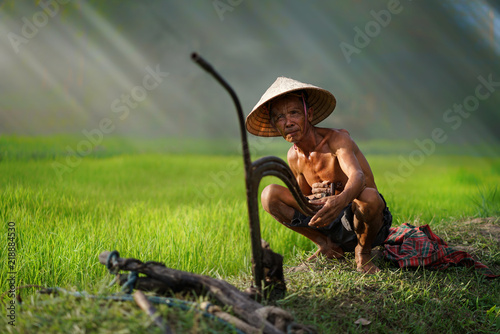 lifestyle of Southeast Asian people in the field countryside vietnam,A farmer sitting in rice fields,